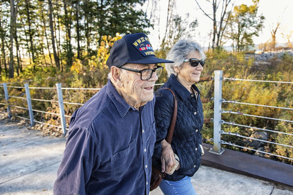 a U.S. veteran walking with his wife in nature
