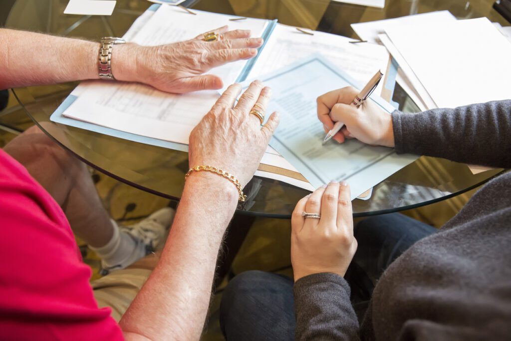 an image with an elder man and a younger person that represents a legal agreement and the nature of a trust during estate planning